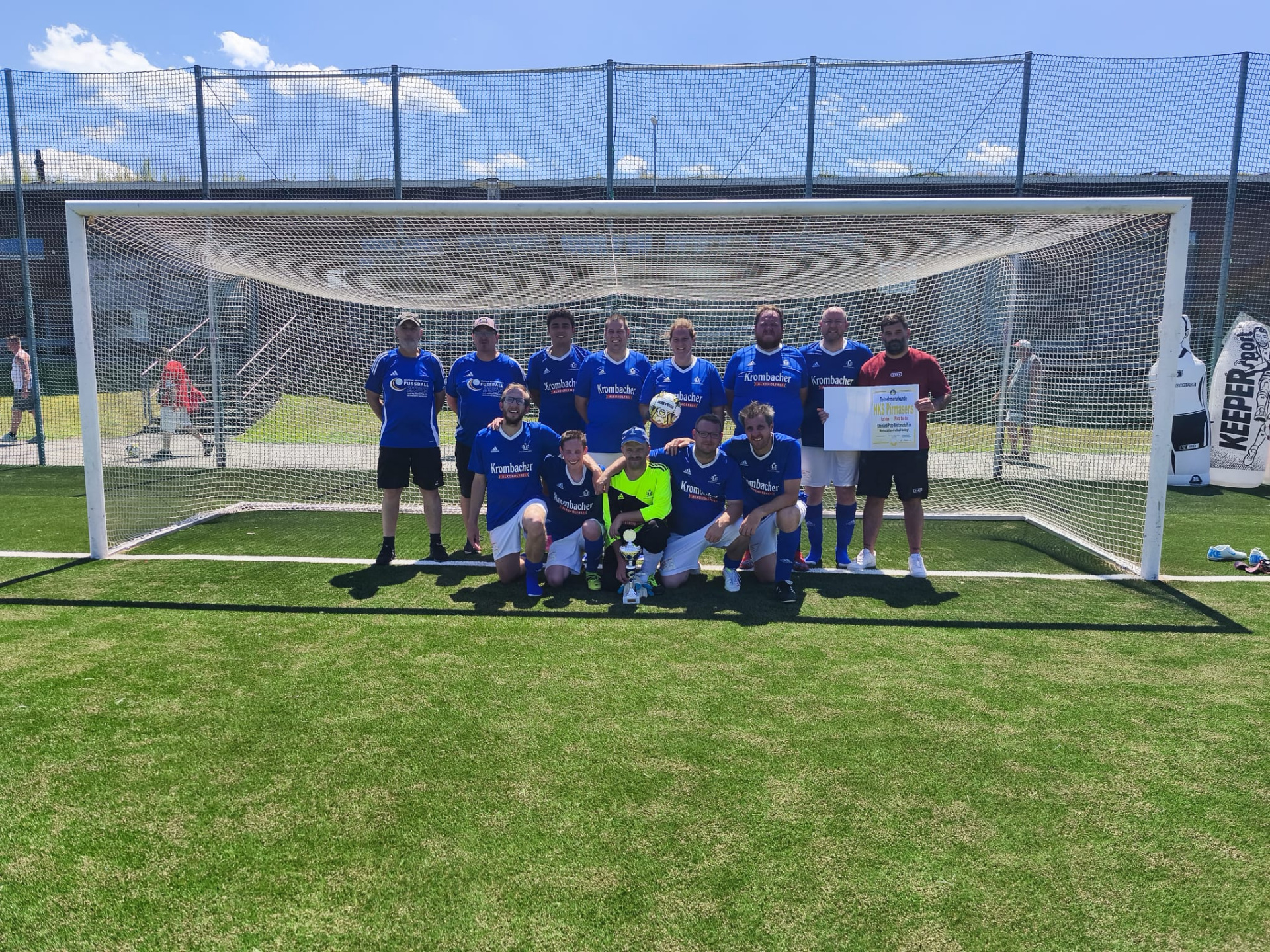 Teamfoto. Fußballteam steht im Tor, blaue Trikots, der Torwart hält die Teilnehmerurkunde 
&copy; Heinrich Kimmle Stiftung